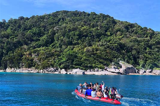 guests going to the beach with the dinghy